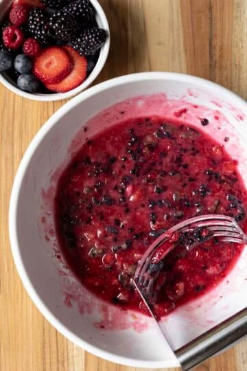 Mixing arrowroot starch into the mashed berries to help the filling set.