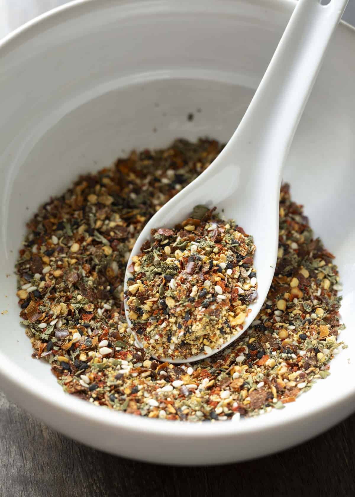 Togarashi seasoning in a white bowl before being ground to a finer consistency.