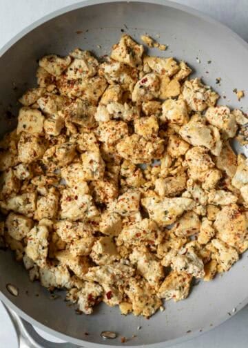 Adding togarashi seasoning to the tofu scramble.