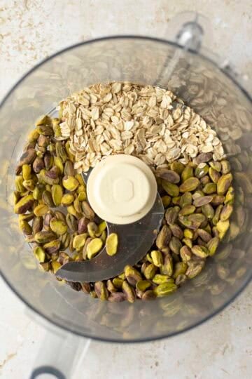 Pistachios and rolled oats in a food processor.