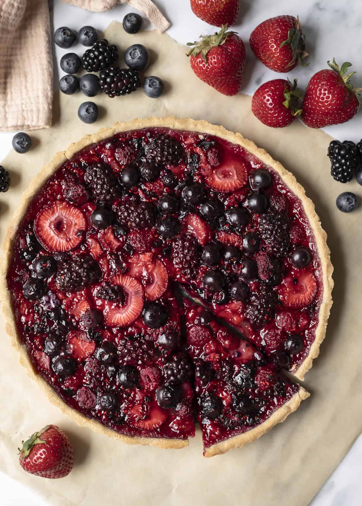 A berry tart made with blueberries, strawberries and blackberries.
