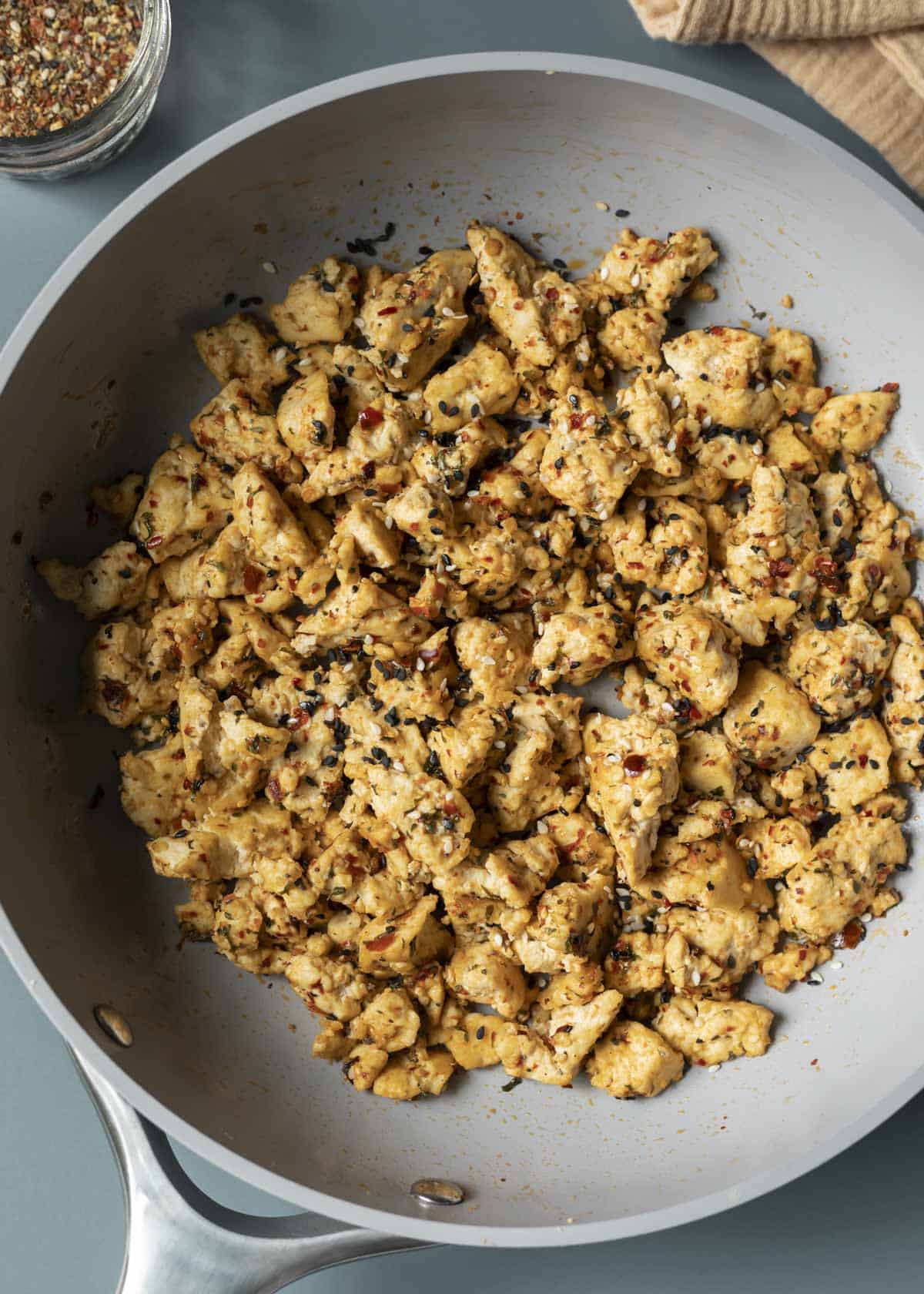 Tofu scramble in a pan seasoned with shichimi togarashi blend.