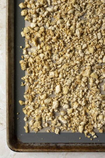 The tofu crumbles on a sheet pan after the initial bake.