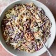 A serving bowl filled with homemade vegan coleslaw.