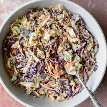 A serving bowl filled with homemade vegan coleslaw.
