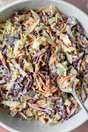 A serving bowl filled with homemade vegan coleslaw.