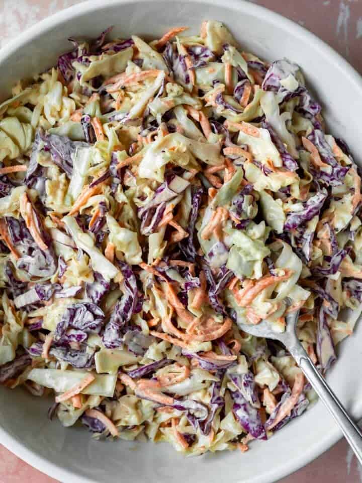 A serving bowl filled with homemade vegan coleslaw.