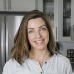 Lori standing in her kitchen.