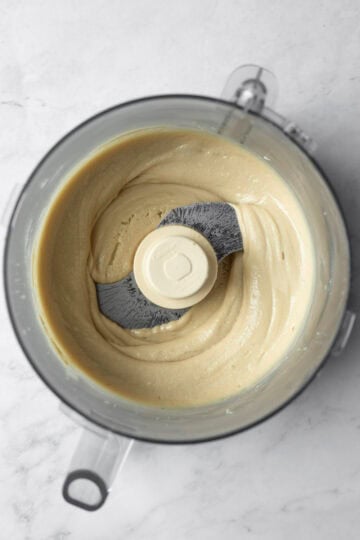 Making blanched almond butter in a food processor.
