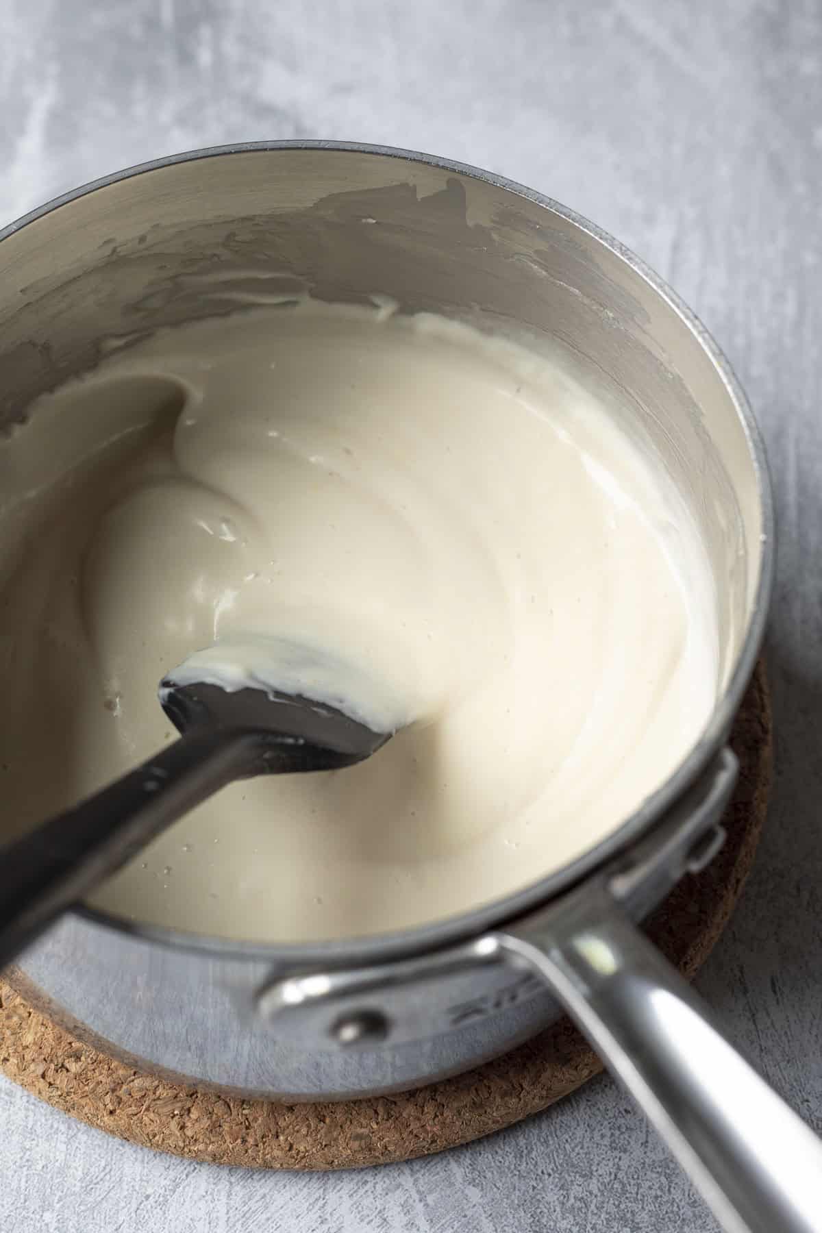 Stirring and heating the mixture on the stovetop until thickened.