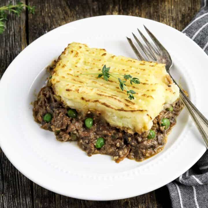 A serving of vegan shepherd's pie on a white plate.