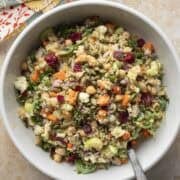 Overhead view of colorful autumn bulgur salad in a white serving bowl.