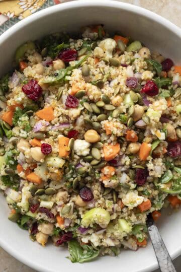 Overhead view of colorful autumn bulgur salad in a white serving bowl.