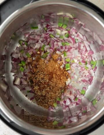 Sauteing onion, jalapeno, and chili spices in the Instant Pot.