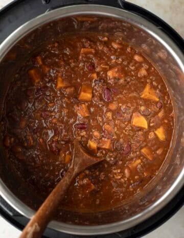 Thickening the chili with TVP and stirring to release starches from the beans.