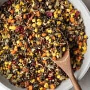 Wild rice with corn, cranberries, and other vegetables in a large pan.
