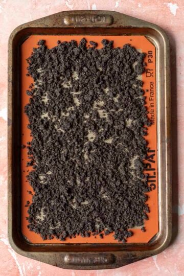 Almond flour chocolate dirt mixture spread on a baking sheet.