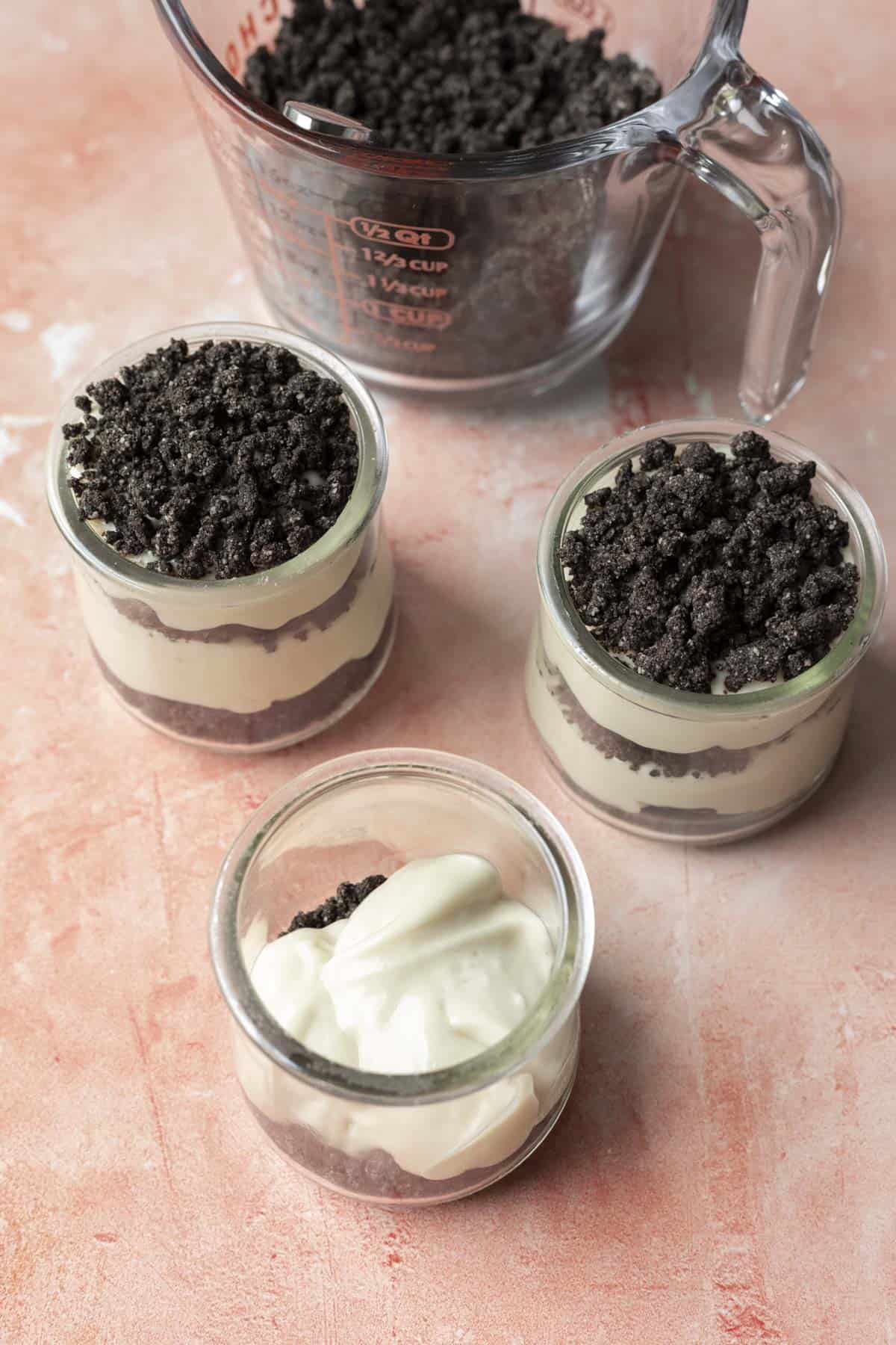 Showing how to layer dirt cake in individual cups.