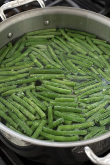 Blanching fresh green beans in salted water.