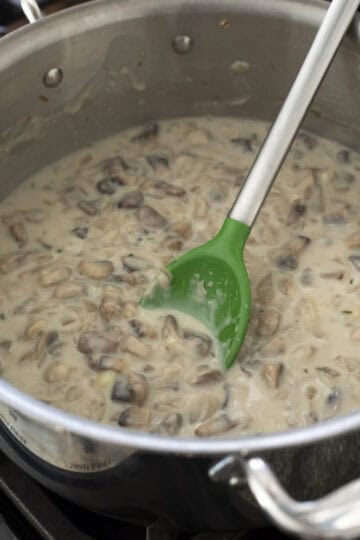 Adding flour and non-dairy milk to the mushroom sauce.