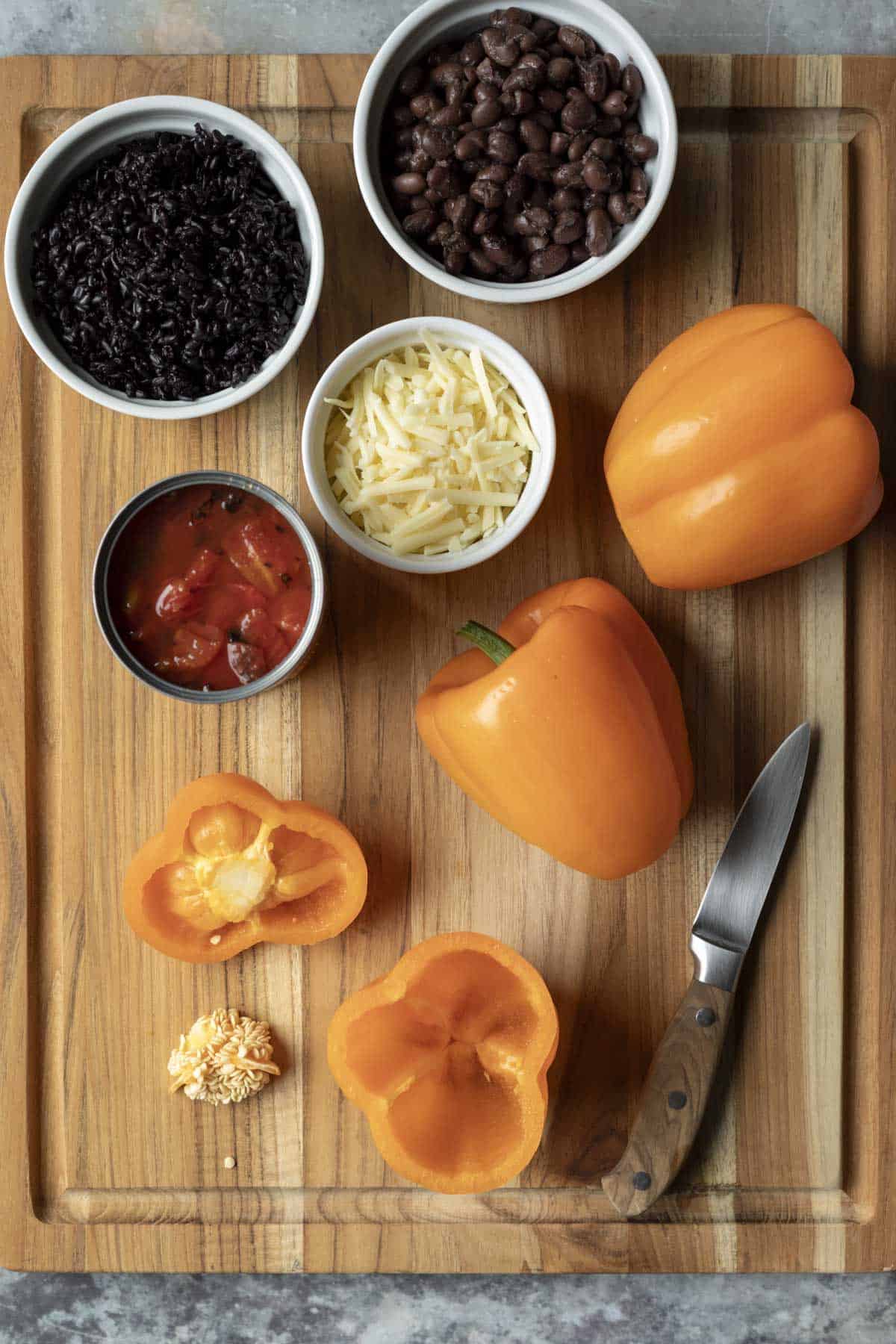 Showing how to carve the peppers plus ingredients needed on a wood board.
