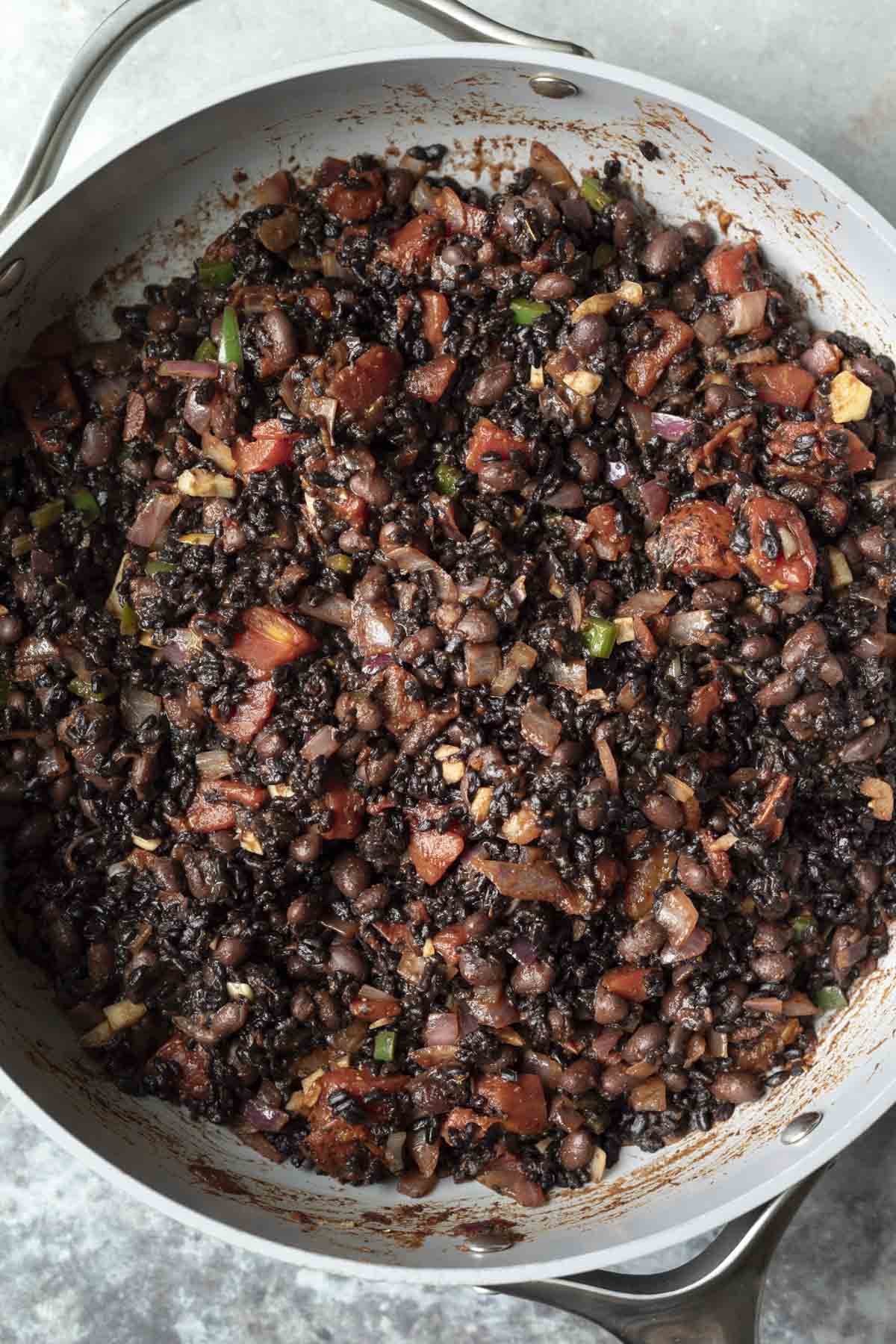 Black beans and black rice added to the skilleet.