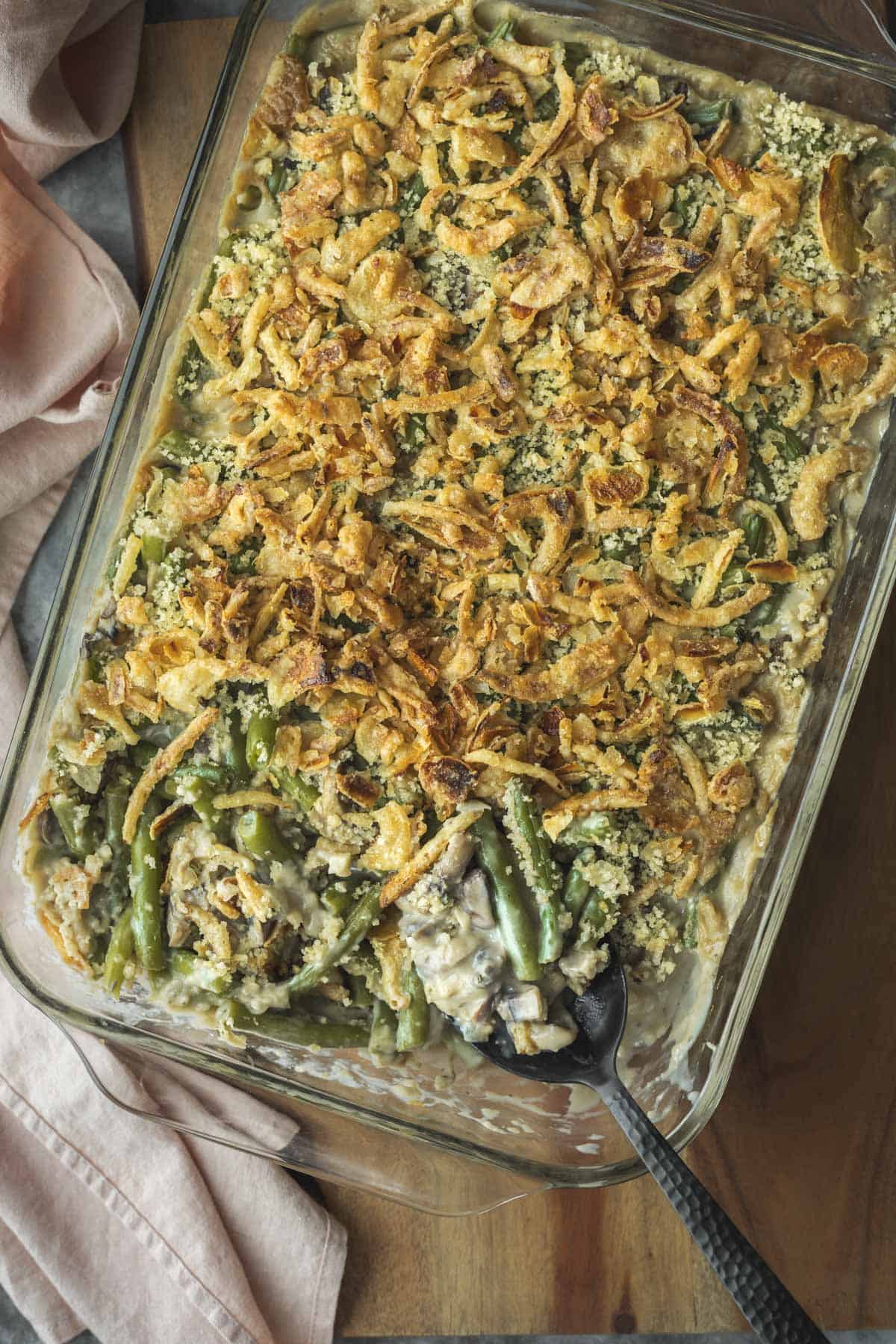 Overhead view of homemade green bean casserole in a glass casserole dish.
