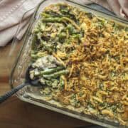 A serving spoon scooping up vegan green bean casserole.