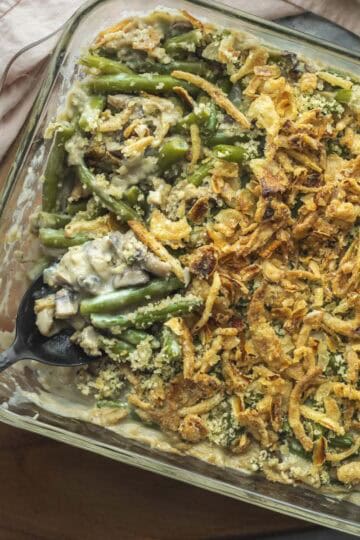 A serving spoon scooping up vegan green bean casserole.