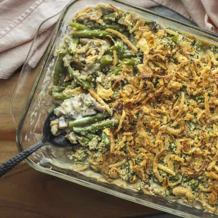 A serving spoon scooping up vegan green bean casserole.
