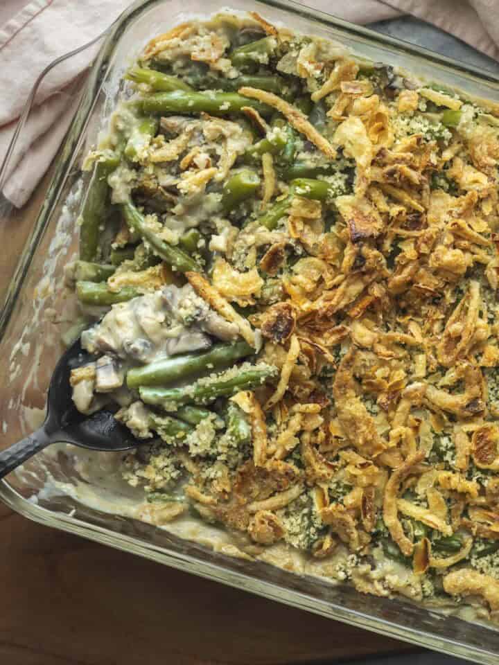 A serving spoon scooping up vegan green bean casserole.