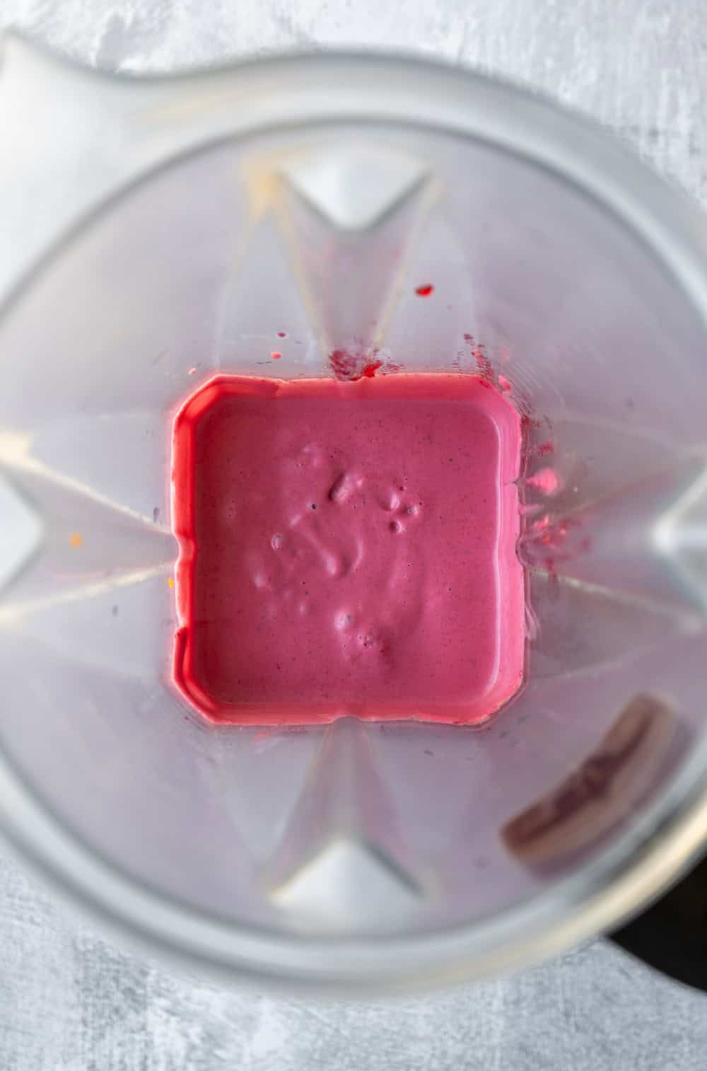 Creamy cranberry slaw dressing inside the blender.