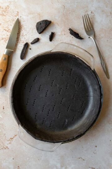 Trimming excess dough around the edges of the pie plate.