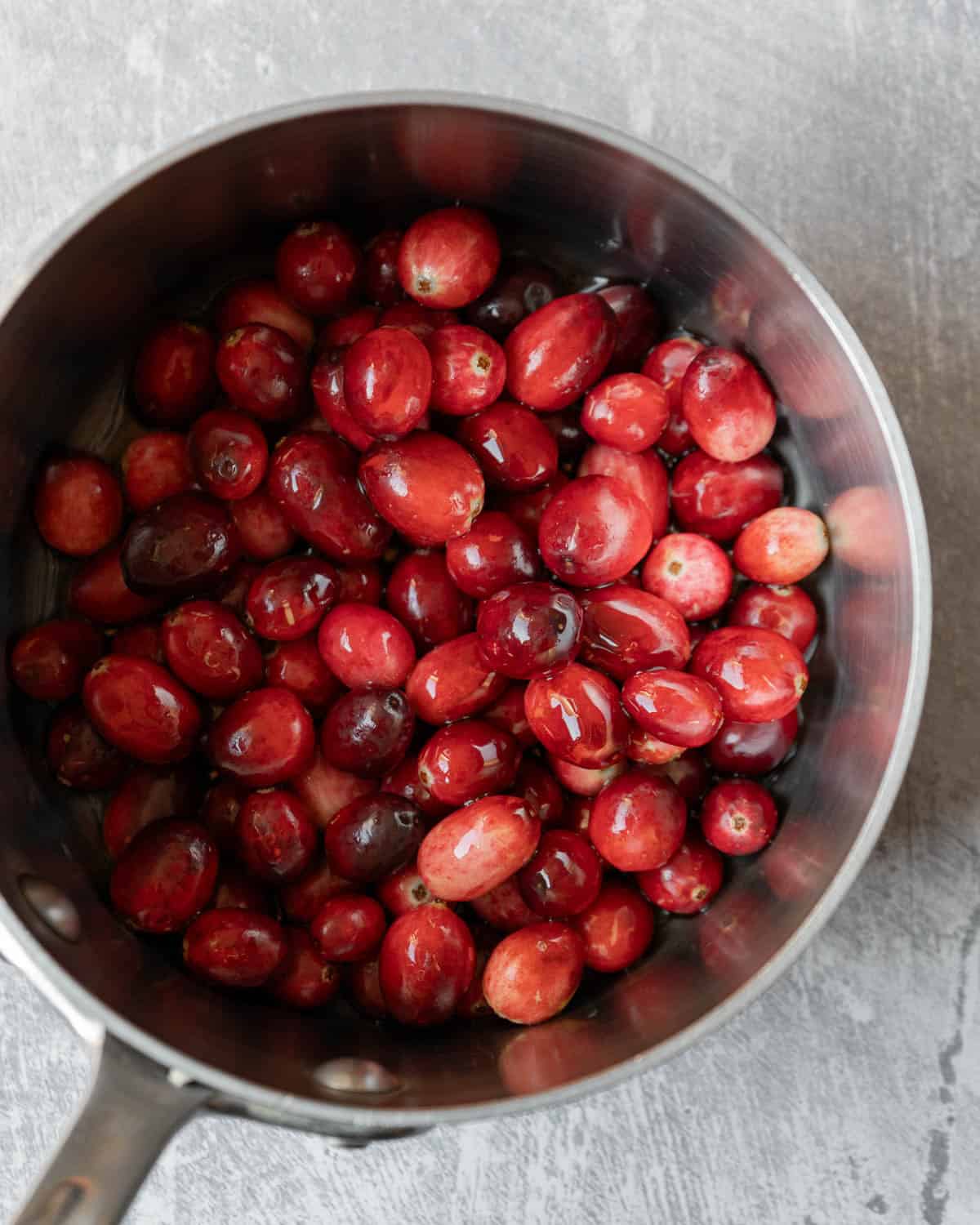 Making a quick batch of cranberry sauce for the base of the dressing.