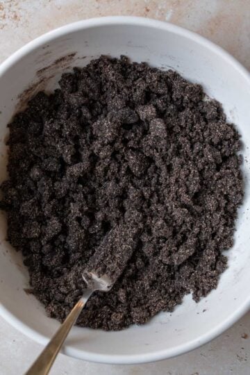 Mixing sugar and water into dry ingredients.