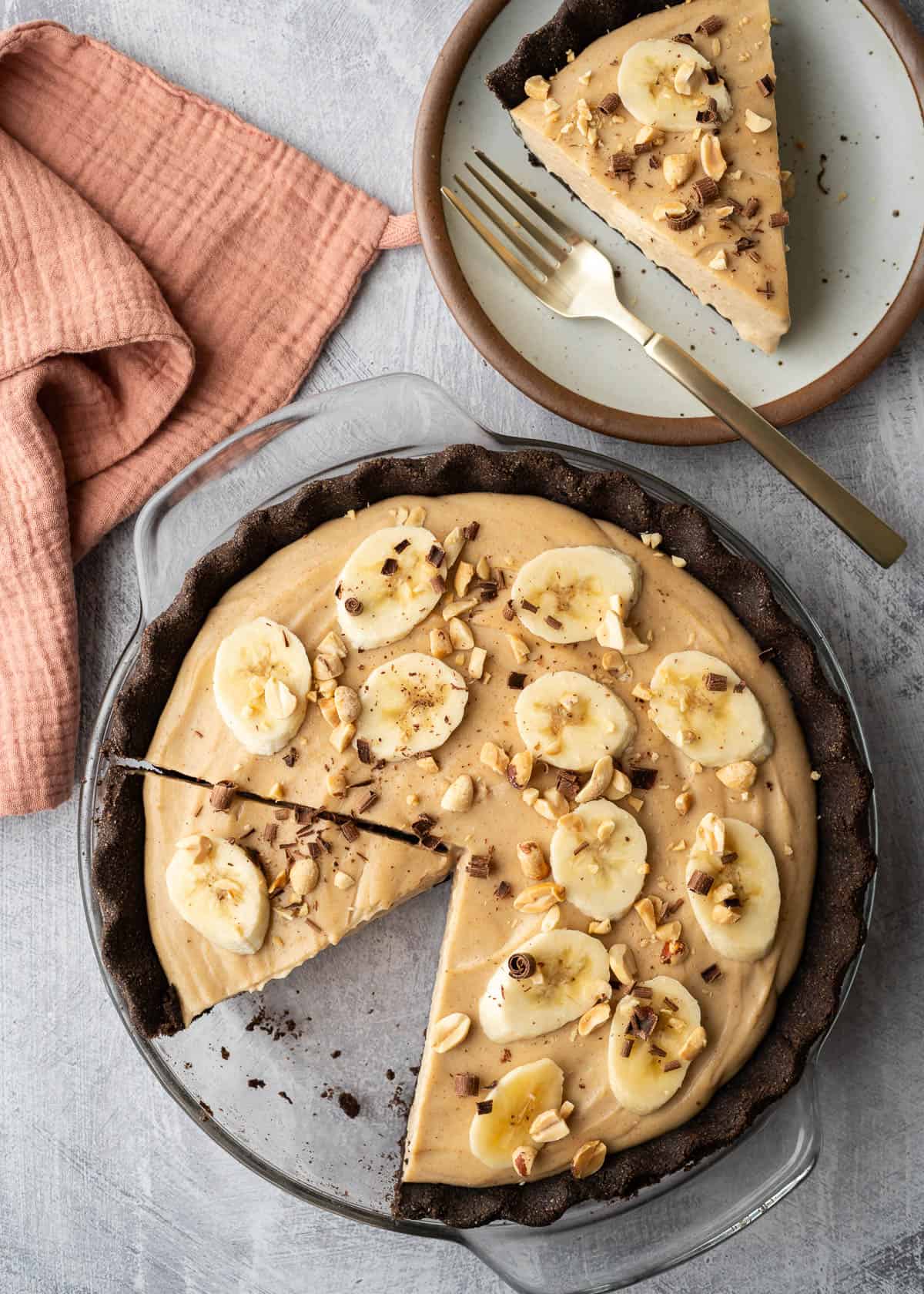 Dairy free peanut butter pie with one slice removed and on a plate.