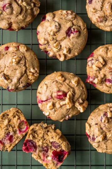 Orange cranberry oatmeal muffins with walnuts on a cooling rack.