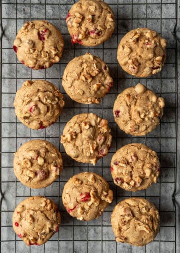 One dozen muffins cooling on a wire rack.