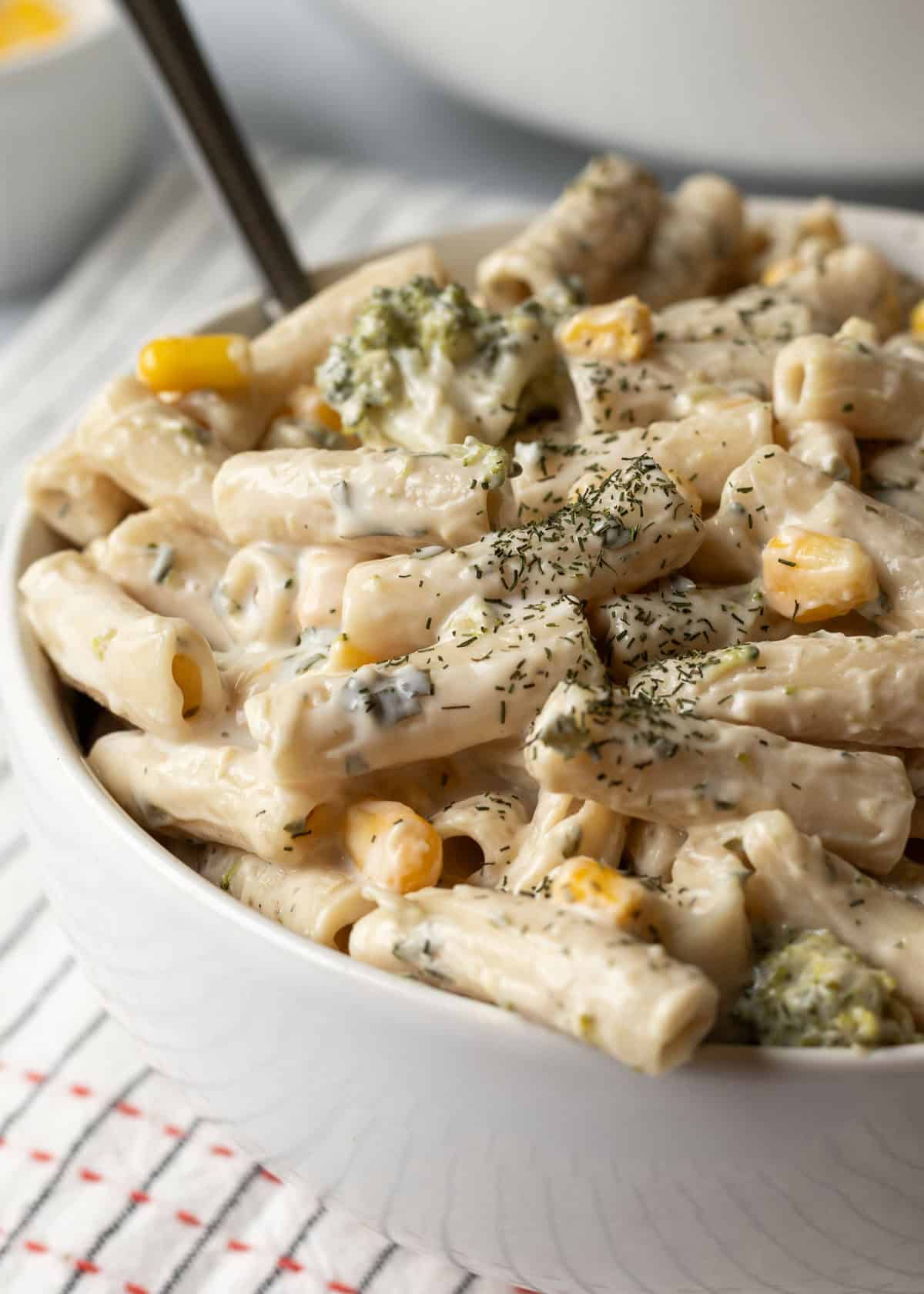Close up view of ranch pasta salad in a white bowl.