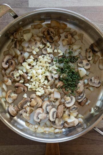 Sauteing onion, mushrooms, garlic, and thyme for chickpea loaf.