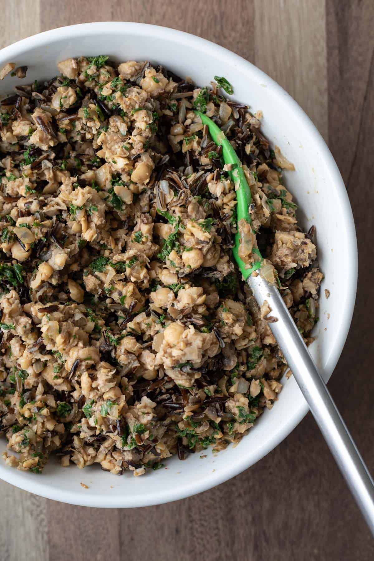 Folding all of the chickpea meatloaf ingredients together in a large bowl.