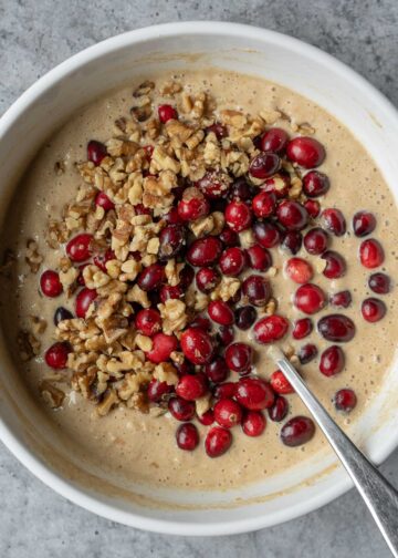 Folding cranberries and walnuts into the batter.
