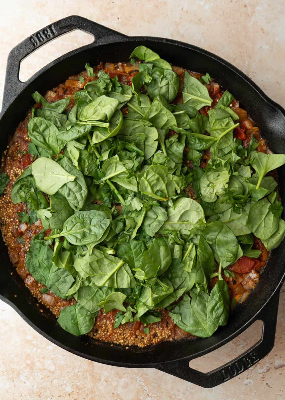 Baby spinach and chickpeas added on top of the quinoa for the final few minutes of cooking.