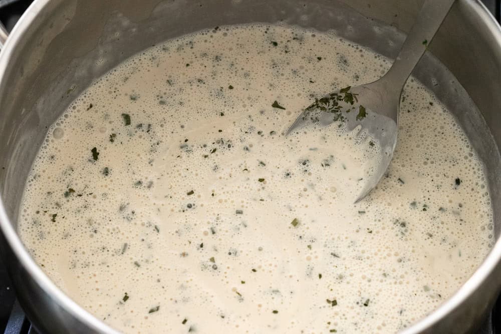 Showing hte consistency of the dairy-free ranch sauce in the pot before heating.