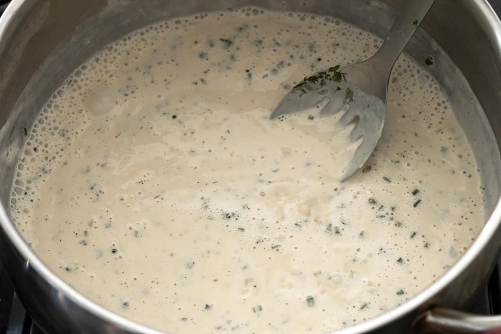 Thickened ranch pasta sauce in a pot after heating.