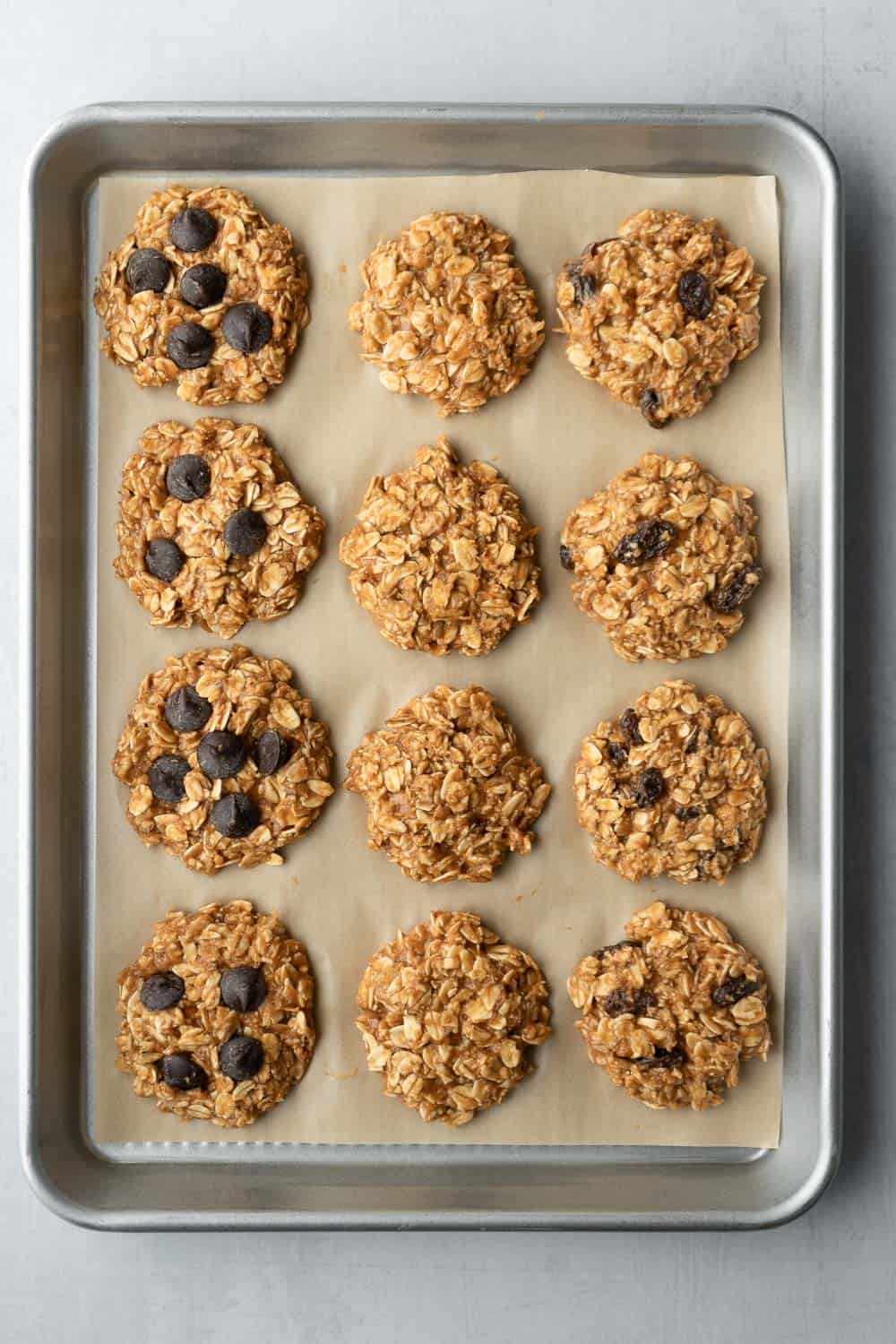 Unbaked cookies portioned out and on a parchment lined baking sheet.