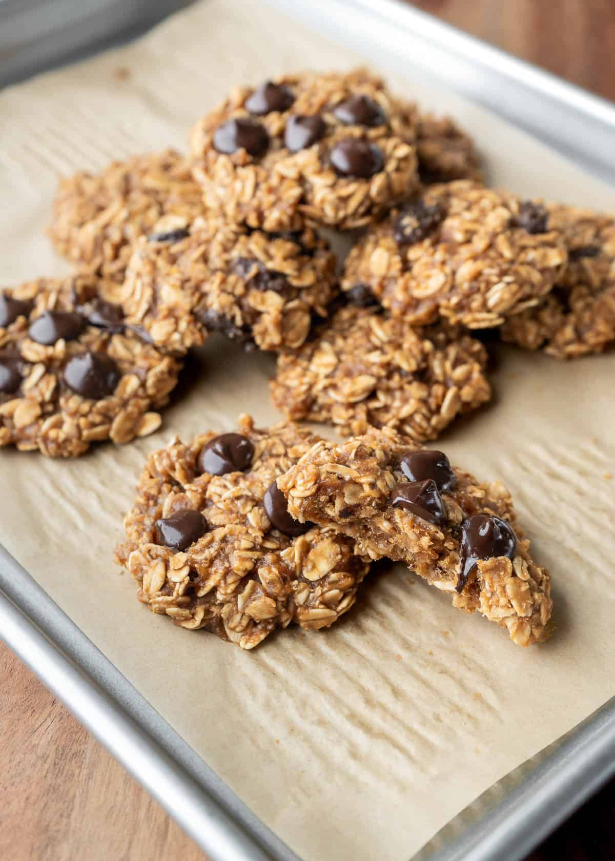 Soft and chewy oatmeal PB2 cookies on a parchment-lined baking sheet.