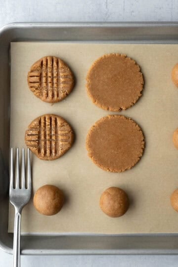 Showing how to flatten the cookies into shape.