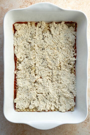 A thin layer of tofu ricotta spread over the pre-boiled pasta.