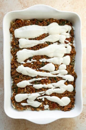 Vegan meat sauce spread over the ricotta and topped with creamy, bechamel-like vegan mozzarella.